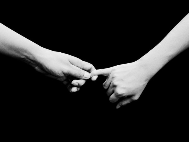Two person hold hands