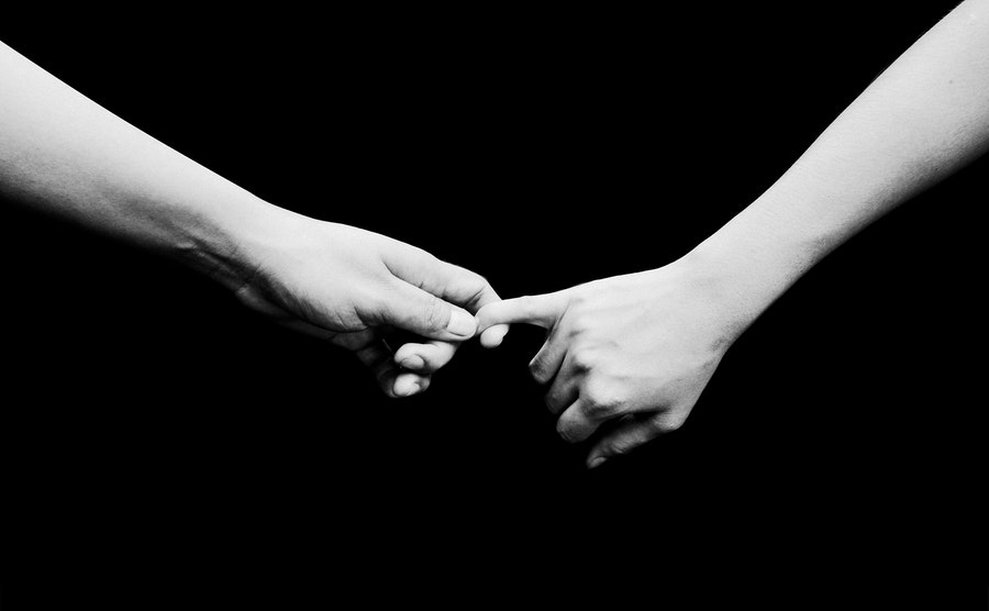 Two person hold hands